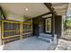 Back porch features black paneling, concrete floor, black and yellow door, and steps at 2020 Palmer St, Orlando, FL 32803