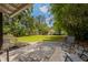 Landscaped backyard features brick patio, shed, manicured lawn, and mature trees at 2020 Palmer St, Orlando, FL 32803