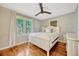 Bright bedroom features hardwood floors, ceiling fan, large windows, and white wooden furniture at 2020 Palmer St, Orlando, FL 32803