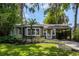 Charming home exterior featuring mature landscaping, a covered carport and classic architectural details at 2020 Palmer St, Orlando, FL 32803