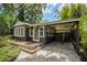 Charming home exterior boasting mature landscaping, a covered carport, and a brick paver driveway at 2020 Palmer St, Orlando, FL 32803
