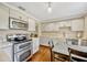 Bright kitchen features stainless steel appliances, white cabinets, hardwood floors, and modern lighting at 2020 Palmer St, Orlando, FL 32803