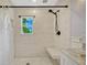 Shower features white subway tile, dark fixtures, a built in bench, and hexagon tile floor at 2020 Palmer St, Orlando, FL 32803