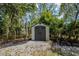 The backyard features a convenient storage shed nestled among trees at 2020 Palmer St, Orlando, FL 32803