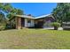 Inviting backyard with lawn, brick accents, screened-in patio, and mature landscaping at 203 E Greentree Ln, Lake Mary, FL 32746