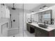 The bathroom features a glass-enclosed shower, dual vanity with white counters and modern fixtures at 203 E Greentree Ln, Lake Mary, FL 32746