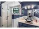 Stylish bathroom showcasing a glass enclosed shower, modern vanity, and decorative lighting at 203 E Greentree Ln, Lake Mary, FL 32746