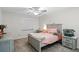 Serene bedroom features neutral walls, carpet, ceiling fan and a charming bed with matching end tables at 203 E Greentree Ln, Lake Mary, FL 32746