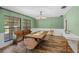 Elegant dining room with stylish chandelier, wood-look tile flooring, and rustic bench seating at 203 E Greentree Ln, Lake Mary, FL 32746