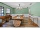 Elegant dining room with stylish chandelier, wood-look tile flooring, and a rustic wooden bench at 203 E Greentree Ln, Lake Mary, FL 32746