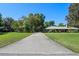 Long driveway leading to a house with extensive yard and mature trees at 203 E Greentree Ln, Lake Mary, FL 32746