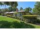 Charming single-story home with manicured landscaping and metal roof at 203 E Greentree Ln, Lake Mary, FL 32746