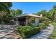 Home with a two car garage, brick details and lush landscaping at 203 E Greentree Ln, Lake Mary, FL 32746