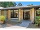 Inviting front porch with brick columns and decorative front door at 203 E Greentree Ln, Lake Mary, FL 32746