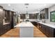 Spacious kitchen with a large island, dark cabinetry, stainless steel appliances, and modern pendant lighting at 203 E Greentree Ln, Lake Mary, FL 32746