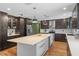 Bright kitchen features a large island, ample cabinet space, stainless steel appliances, and stylish lighting at 203 E Greentree Ln, Lake Mary, FL 32746