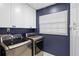 This laundry room features updated washer and dryer appliances, storage cabinets, and a window at 203 E Greentree Ln, Lake Mary, FL 32746