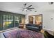 Comfortable living room with large windows, a stylish tufted sofa, and a decorative rug at 203 E Greentree Ln, Lake Mary, FL 32746