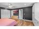 The main bedroom is large with an ensuite bathroom, closet, wood floors, ceiling fan, and natural light at 203 E Greentree Ln, Lake Mary, FL 32746