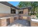 Outdoor kitchen with a sink, grill, stainless steel refrigerator, and brick accents at 203 E Greentree Ln, Lake Mary, FL 32746