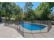 Fenced swimming pool surrounded by a concrete deck and lush greenery at 203 E Greentree Ln, Lake Mary, FL 32746