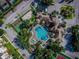 An aerial view of community featuring a pool, basketball court, tennis court, lush landscaping at 2302 Butterfly Palm Way # 105, Kissimmee, FL 34747