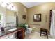 Bathroom features a dark granite vanity top, ample lighting, and accessible shower and toilet at 2302 Butterfly Palm Way # 105, Kissimmee, FL 34747