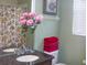 Bathroom featuring a vanity with pink flowers, and a window with blinds at 2302 Butterfly Palm Way # 105, Kissimmee, FL 34747