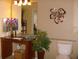 Bathroom with granite countertop, dark wood vanity and a decorative flower wall hanging at 2302 Butterfly Palm Way # 105, Kissimmee, FL 34747