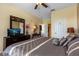 Bright bedroom with a comfortable bed, a dresser, and a view of the room's open layout at 2302 Butterfly Palm Way # 105, Kissimmee, FL 34747