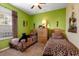 A bedroom with two beds with animal print bedding, green walls and natural light at 2302 Butterfly Palm Way # 105, Kissimmee, FL 34747