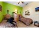 A bedroom with two beds with animal print bedding, green and beige walls and natural light at 2302 Butterfly Palm Way # 105, Kissimmee, FL 34747