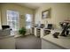 Bright business center with multiple computer workstations, printer, and a view to the outside at 2302 Butterfly Palm Way # 105, Kissimmee, FL 34747