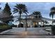 Gated community entrance with black metal gate and landscaped surroundings offers security and peace of mind at 2302 Butterfly Palm Way # 105, Kissimmee, FL 34747