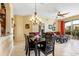 Open-concept dining area with a chandelier, tile floors, and access to the living room at 2302 Butterfly Palm Way # 105, Kissimmee, FL 34747