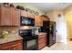 Well-equipped kitchen features stainless steel appliances, wooden cabinets, and granite countertops at 2302 Butterfly Palm Way # 105, Kissimmee, FL 34747