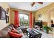 Comfortable living room with sliding glass doors to screened patio, ceiling fan, and neutral tones at 2302 Butterfly Palm Way # 105, Kissimmee, FL 34747