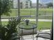 Screened patio with furniture, views of the community lawn and greenery at 2302 Butterfly Palm Way # 105, Kissimmee, FL 34747