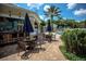 Inviting poolside patio with seating, umbrellas, lush greenery, and an outdoor bar at 2302 Butterfly Palm Way # 105, Kissimmee, FL 34747