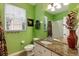Inviting bathroom with granite vanity, large mirror, and plants for freshness at 2302 Silver Palm Dr # 203, Kissimmee, FL 34747