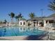 Inviting community pool with tables and chairs for entertaining and relaxing at 2302 Silver Palm Dr # 203, Kissimmee, FL 34747