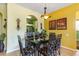 Bright dining area with modern table and chairs, complemented by stylish lighting and colorful wall décor at 2302 Silver Palm Dr # 203, Kissimmee, FL 34747