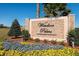 Welcome to Windsor Palms, a gated resort community; the sign is surrounded by colorful flower beds at 2302 Silver Palm Dr # 203, Kissimmee, FL 34747