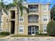 Attractive condo building with screened patios and lush landscaping, showcasing a desirable community living at 2302 Silver Palm Dr # 203, Kissimmee, FL 34747