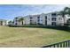 Exterior view of apartment complex showcasing its well-maintained grounds, landscaping, and spacious balconies at 2302 Silver Palm Dr # 203, Kissimmee, FL 34747