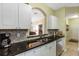 Well-appointed kitchen featuring granite countertops, stainless steel appliances, and a convenient pass-through to the living area at 2302 Silver Palm Dr # 203, Kissimmee, FL 34747