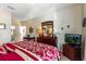 Comfortable primary bedroom offers dresser, mirror, TV, and restful retreat at 2302 Silver Palm Dr # 203, Kissimmee, FL 34747