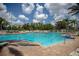 Large pool surrounded by green lush palm trees perfect for relaxation at 2302 Silver Palm Dr # 203, Kissimmee, FL 34747
