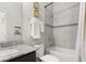 Well-lit bathroom with a combined shower and bathtub and modern granite countertop at 2405 Standing Rock Cir, Oakland, FL 34787