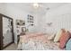 Bright bedroom with a large mirror, desk area, and floral bedding at 2405 Standing Rock Cir, Oakland, FL 34787